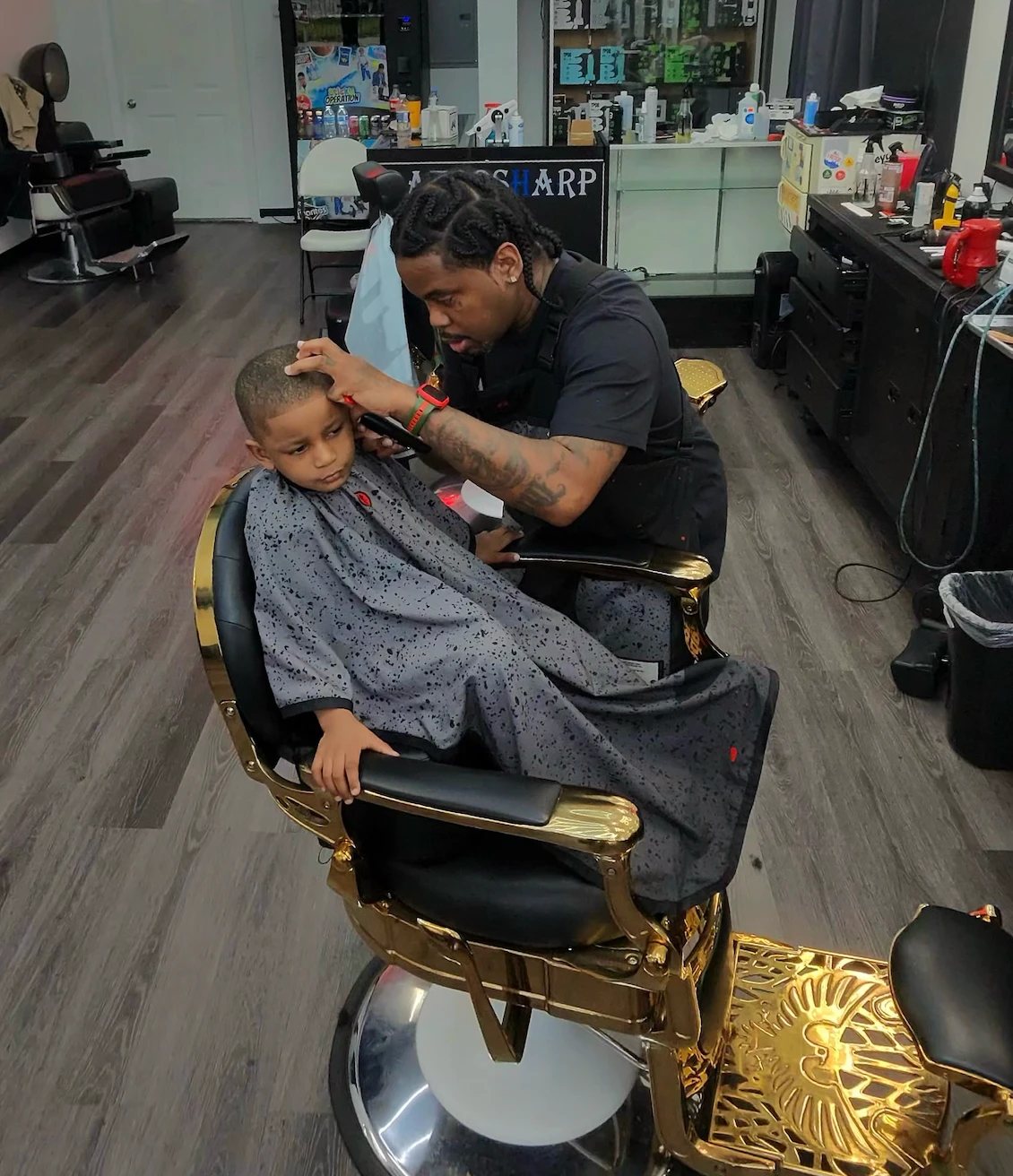 Shawty Da Barber at work on the gold chair